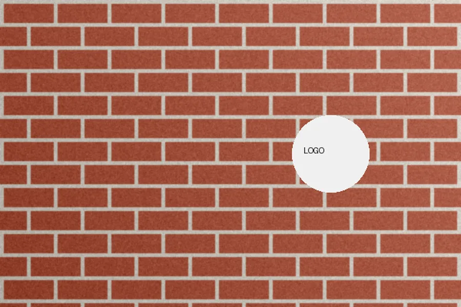 Brick wall with a round white sign on it