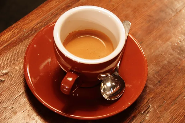 Original photo of an espresso cup on a wooden table